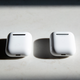 The first generation AirPods (right) appear to have a stainless steel hinge, while the second generation AirPods (left) appear to have an aluminum hinge.